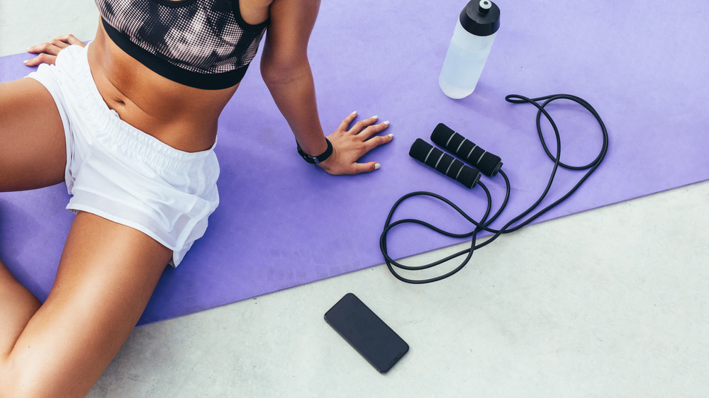 Woman working out, next to jump rope