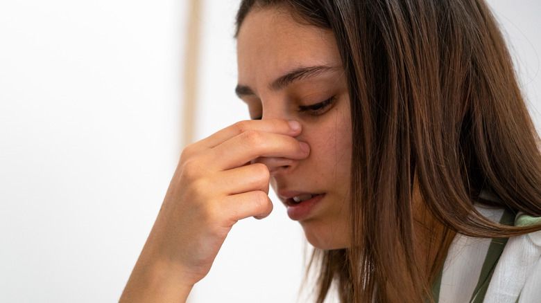 Woman with nose pain 