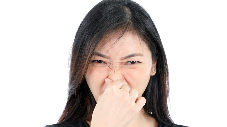 Woman itching her nose