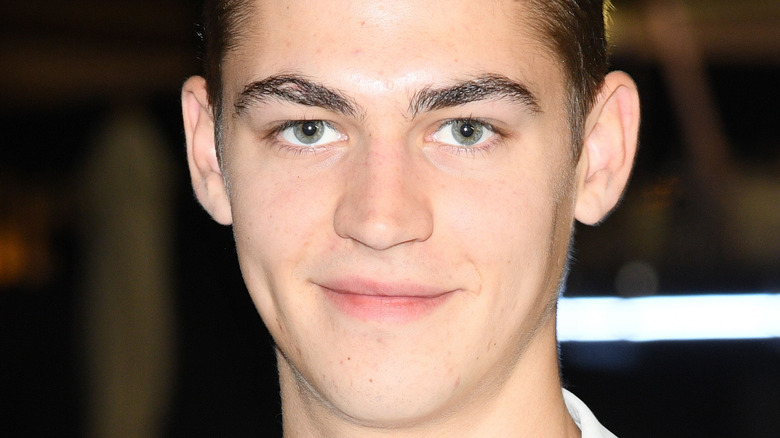 Hero Fiennes Tiffin smiling  