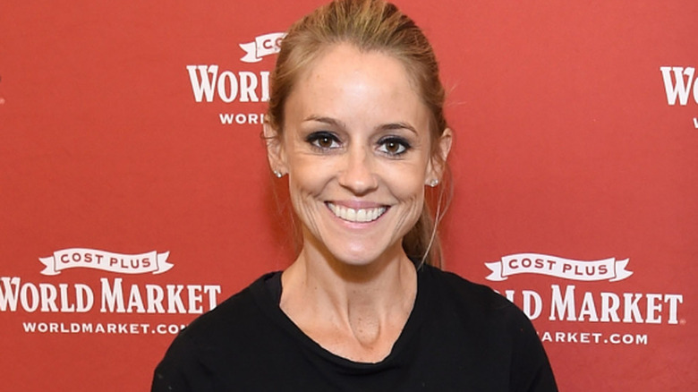 Nicole Curtis smiling while posing at an event in a black top
