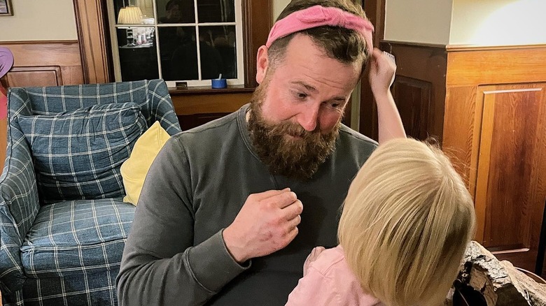 Ben Napier's daughter putting a pink headband on his head while he looks at her adoringly