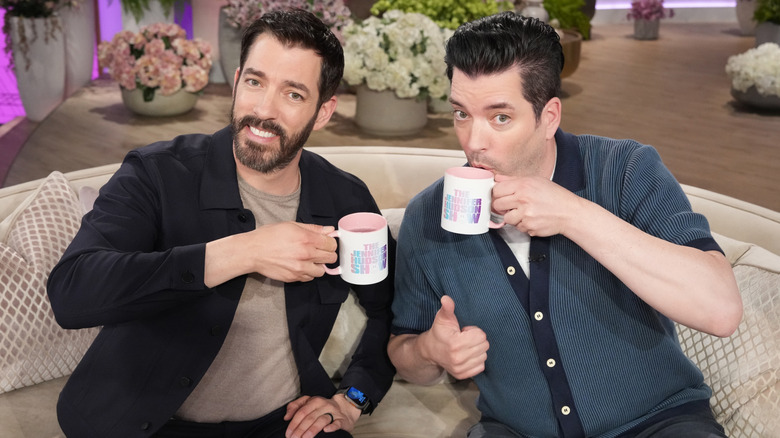 Drew and Jonathan Scott posing with talk show mugs