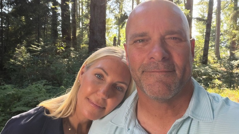 Bryan and Sarah Baeumler smiling in a wooded area
