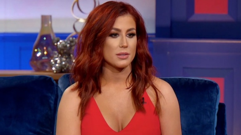 Chelsea DeBoer with red hair and wearing a red dress