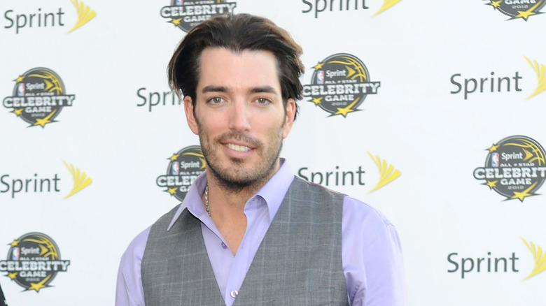 Jonathan Scott smiling in front of white backdrop
