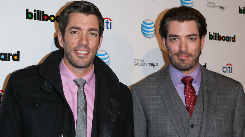 Drew Scott and Jonathan Scott wearing suits