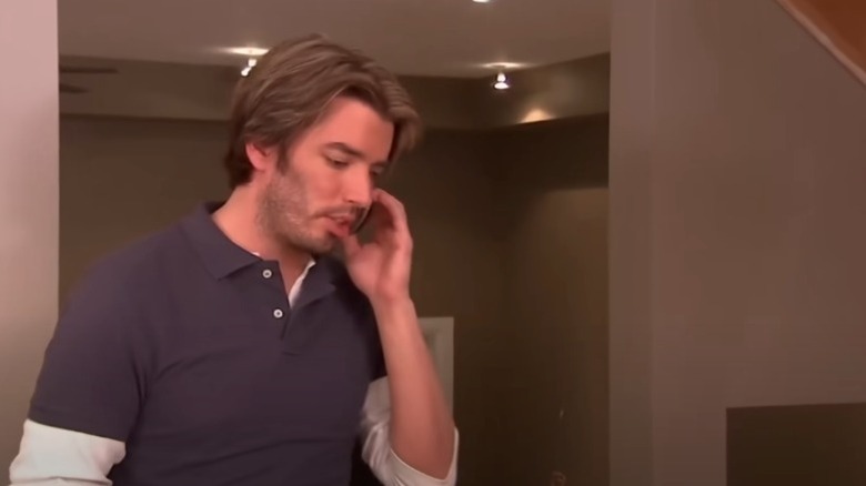 Jonathan Scott with dyed-blond hair standing next to Drew Scott in a 'Property Brothers' episode