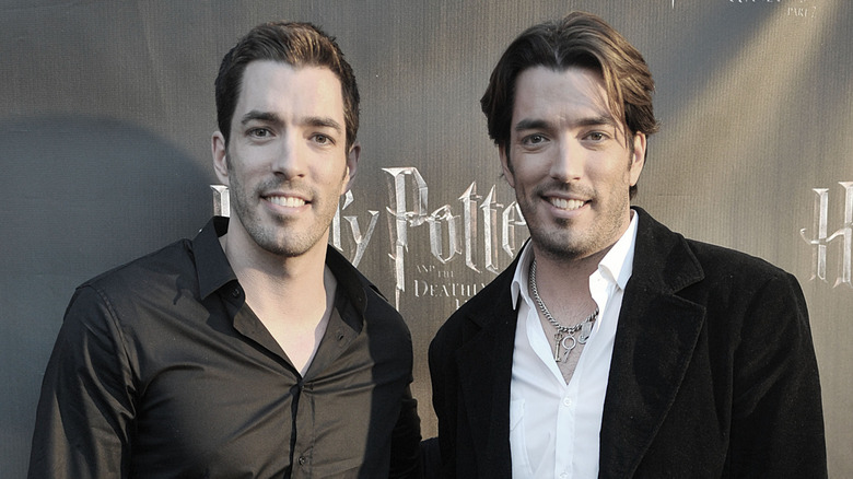 Drew Scott and Jonathan Scott in front of a 'Harry Potter' backdrop