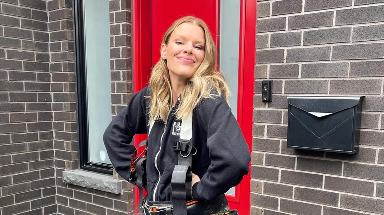 Sherry Holmes posing in a toolbelt 