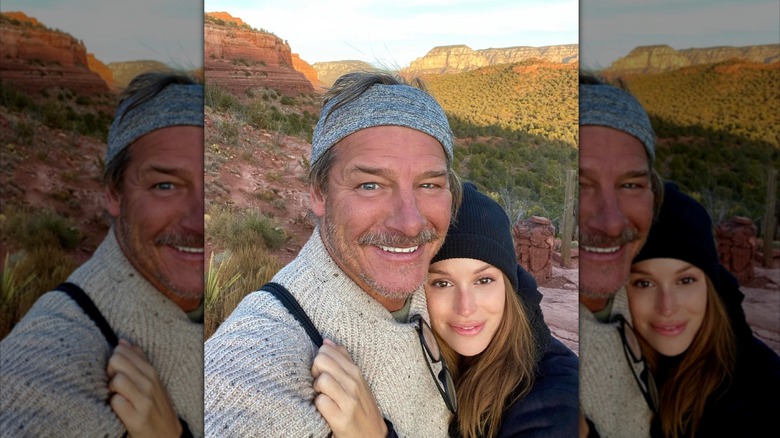 Ty Pennington and Kellee Merrell pose in front of mountains