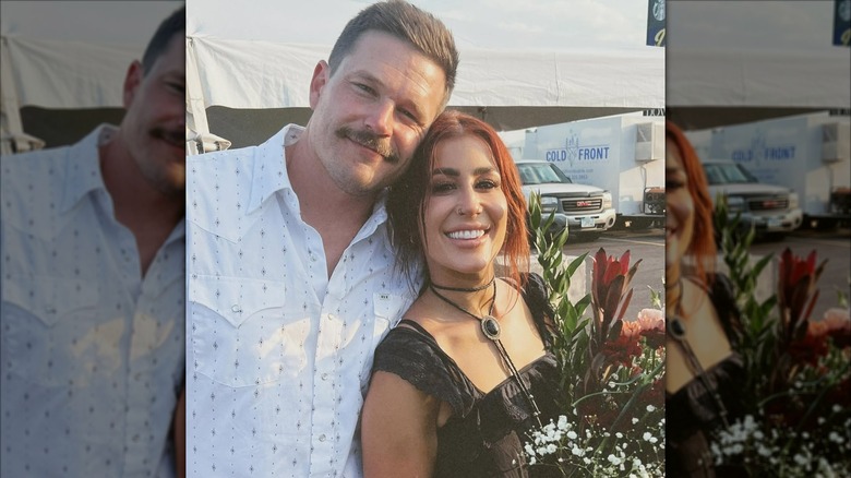 Chelsea Houska smiling for photos with her husband