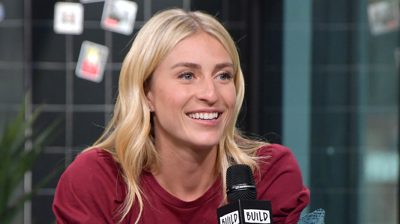 Jasmine Roth holding a microphone during a discussion in 2019