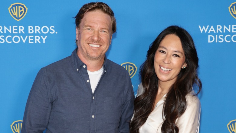 Chip and Joanna Gaines smile while attending an event