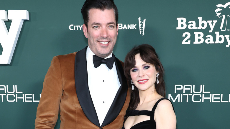 Jonathan Scott and Zooey Deschanel smile side by side