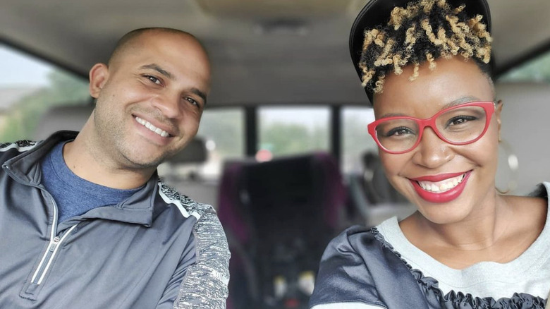 Jon Pierre and Mary Tjon-Joe-Pin smiling in a car