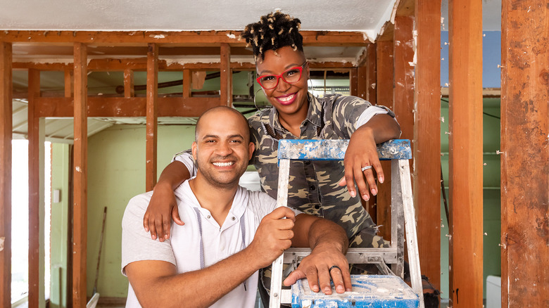 Jon Pierre and Mary Tjon-Joe-Pin on a ladder