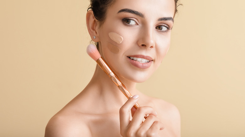 Woman applying foundation 