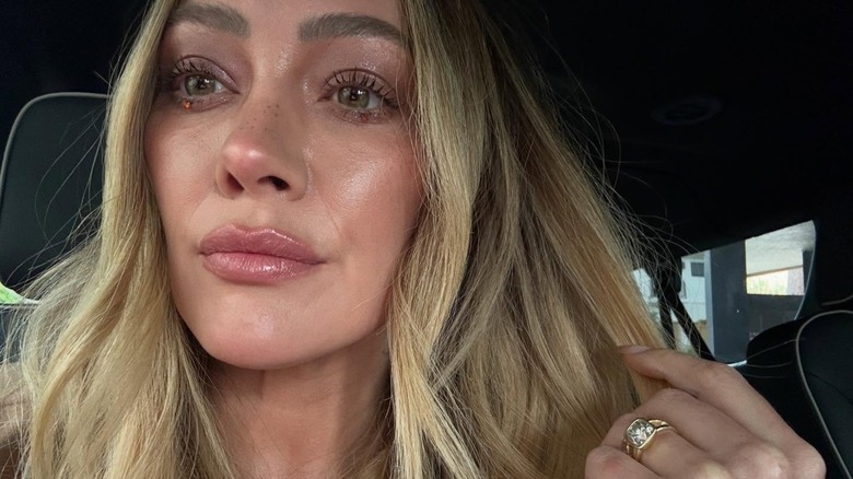 Hilary Duff posing for a selfie in her car