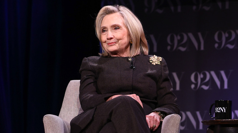 Hillary Clinton sits in a chair