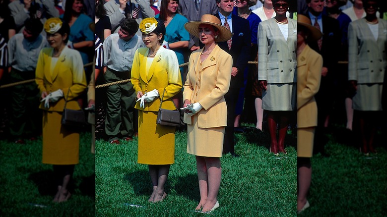 First Lady Hillary Rodham Clinton and Empress Michiko of Japan stand on the South Lawn of the White House as they watch the official welcoming ceremony on June 13, 1994 in Washington, DC (1994)