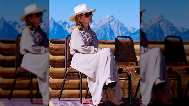 Hillary Clinton sits on a chair as she enjoys a vacation with her family in Wyoming in August 1995 (1995)