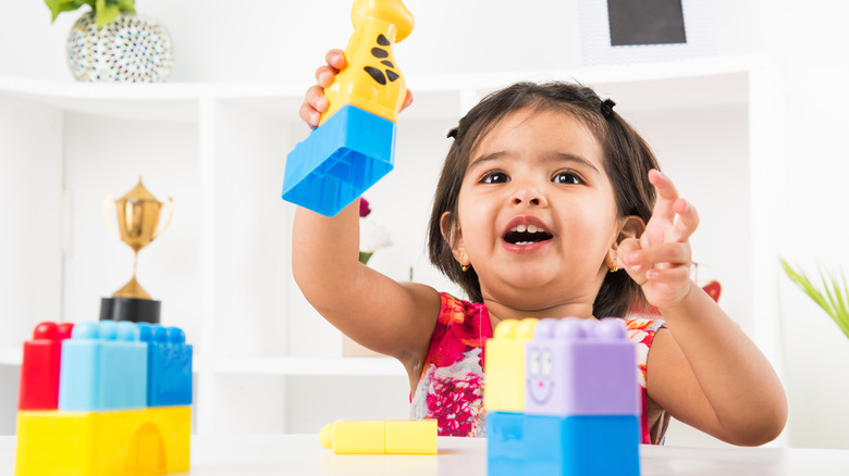 baby girl playing with toys