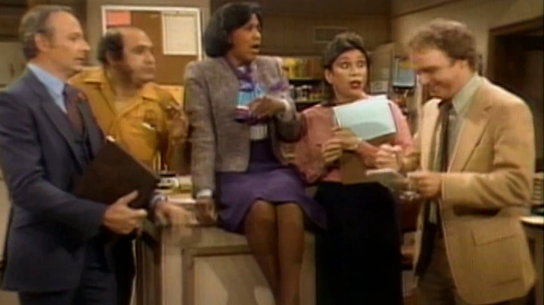 The cast of Checking In in the show's opening credits