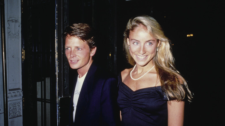Michael J. Fox and Tracy Polllan walking and holding hands.