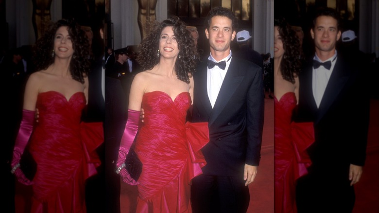 Rita Wilson and Tom Hanks with their arms around each other posing on the red carpet.