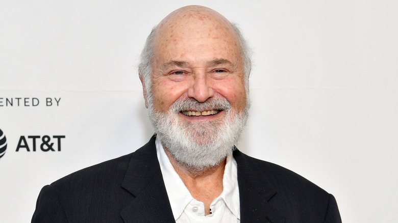 Rob Reiner smiles while attending a red carpet function