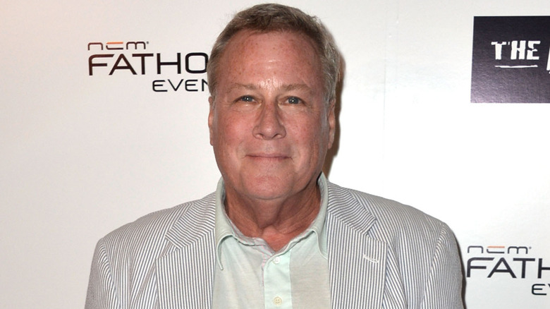 John Heard in a white striped jacket and white shirt