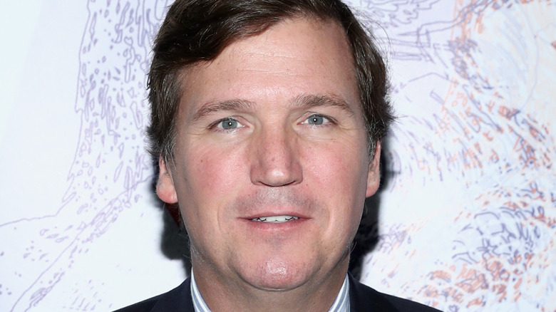 Tucker Carlson posing for picture