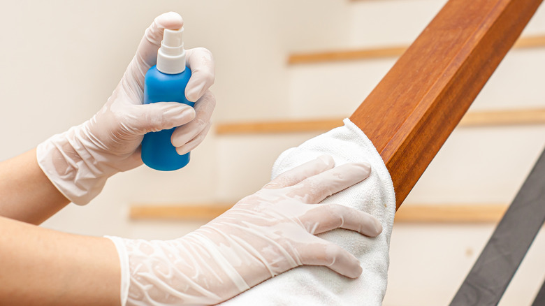 Woman cleaning a staircase hand rail