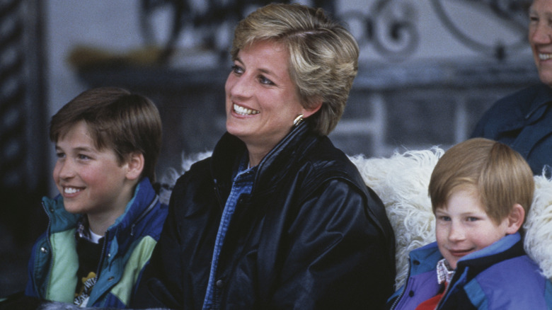Princess Diana smiling with young William, Prince of Wales and Prince Harry between her
