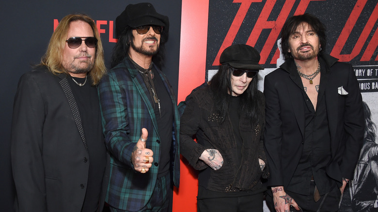 Vince Neil, Nikki Sixx, Mick Mars, and Tommy Lee standing together