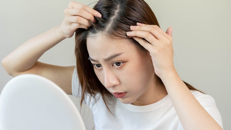 woman noticing thinning hair