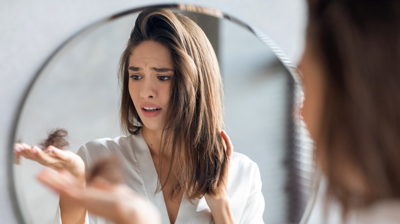 woman shocked to see her hair come out