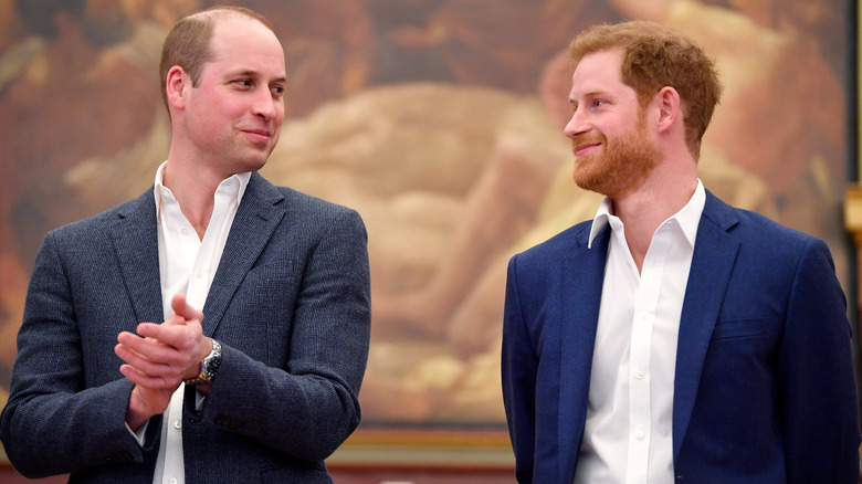 Prince Harry and Prince William smiling at each other
