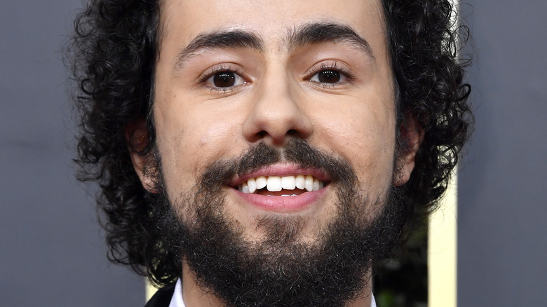 Ramy Youssef smiling on the red carpet