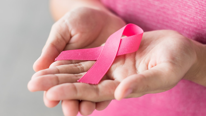 Woman holding breast cancer awareness ribbon