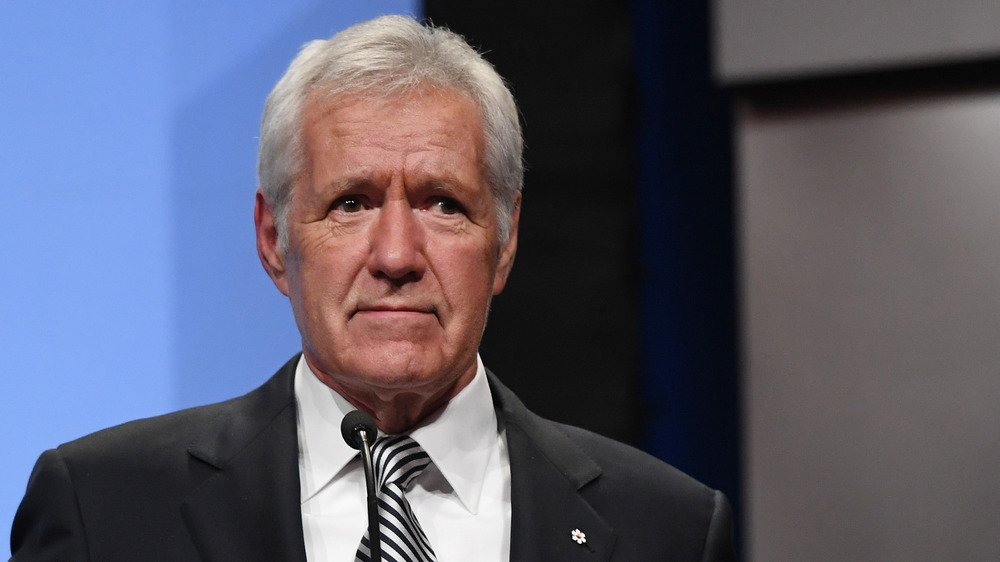 Alex Trebek in striped tie looking serious