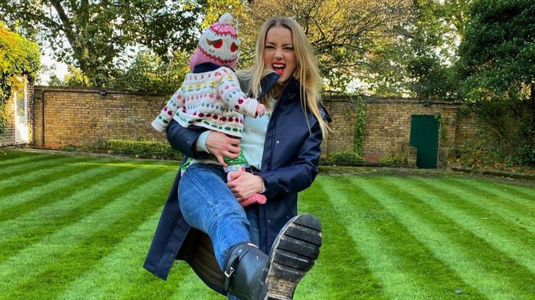 Amber Heard holding Oonagh Paige