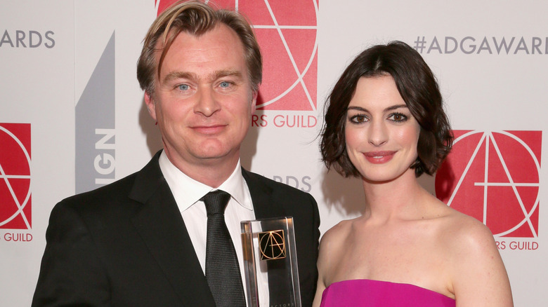 Christopher Nolan and Anne Hathaway smiling