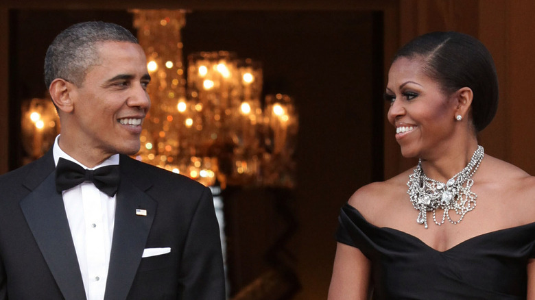 Barack and Michelle Obama smiling at each other