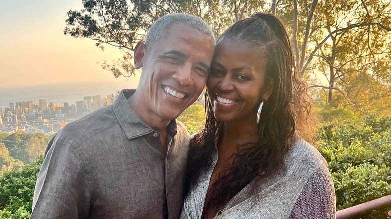 Former President Barack Obama and former First Lady Michelle pose for a picture