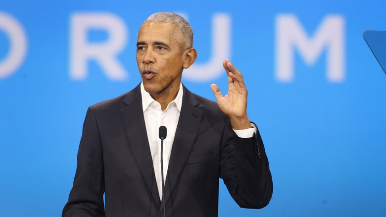 Barack Obama speaking at a podium 