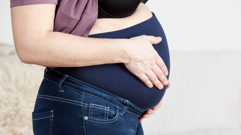 Pregnant woman wearing a belly band