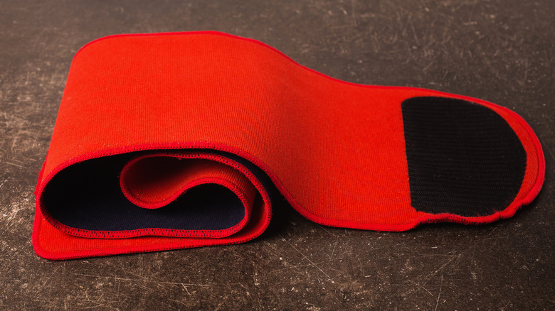 Red pregnancy belly band on a dark background 