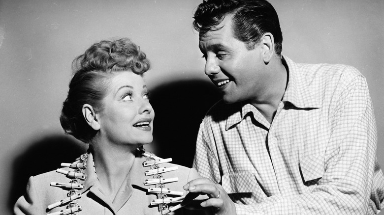 Black and white photo of Desi Arnaz looking at Lucille Ball.